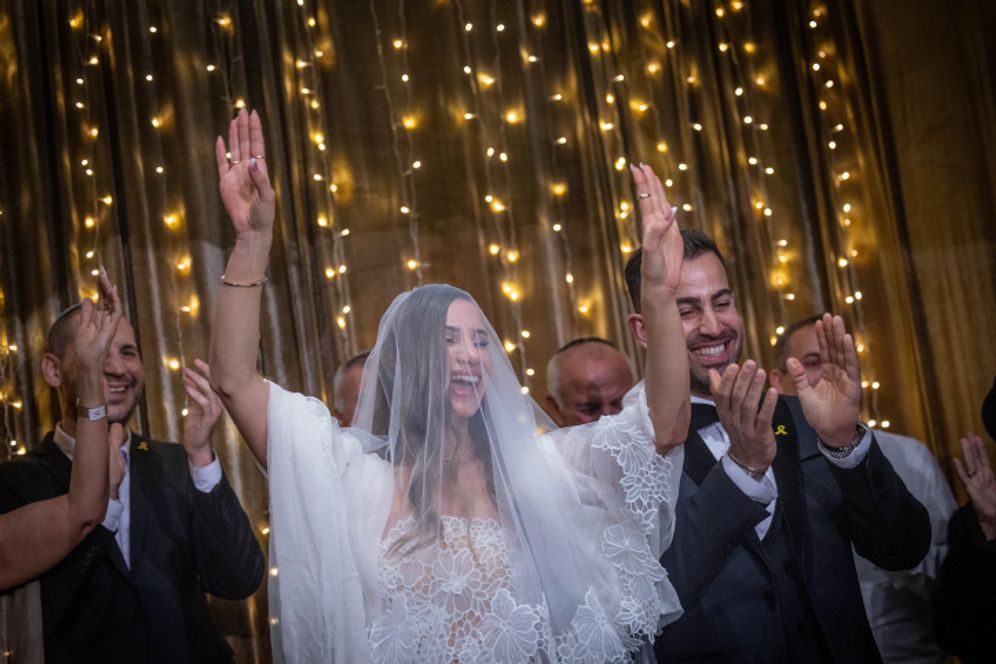 Ten Israeli couples with a member serving in the IDF take part in a mass wedding ceremony, part of Chabad of Savyon’s “Marrying the Warriors”, in Tel Aviv Port, Israel.