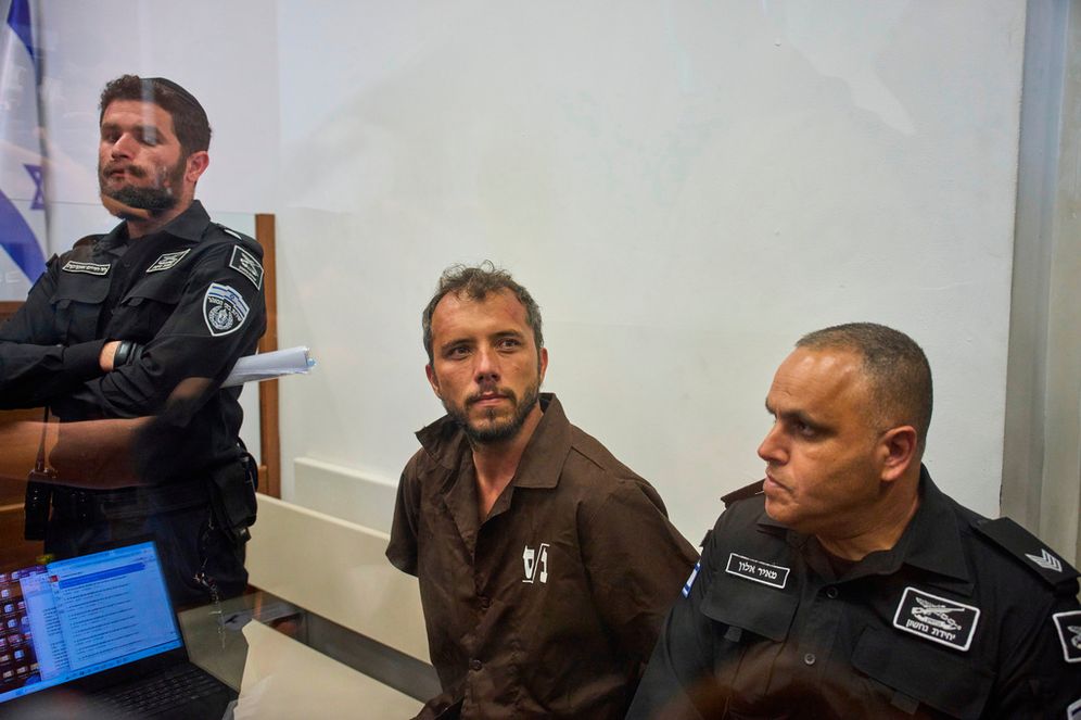 Brazilian activist Thiago Ávila, center, a member of the Global Sumud Flotilla, is escorted by prison service guards to a hearing at the District Court in Ashkelon, Israel, on Sunday, May 3, 2026. 