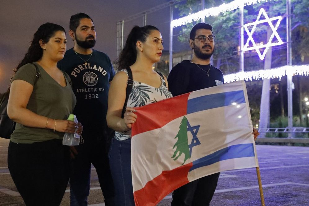 Former Israeli soldiers and fighters of the South Lebanon Army and their relatives wave the Israeli and Lebanese flag during a gathering in Tel Aviv's Rabin Square, Israel.
