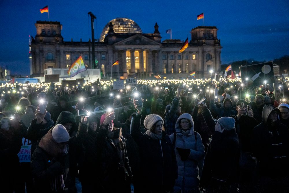 People hold up their cell phones as they protest against the AfD party and right-wing extremism in front of the Reichstag building in Berlin, Germany, January 21, 2024.