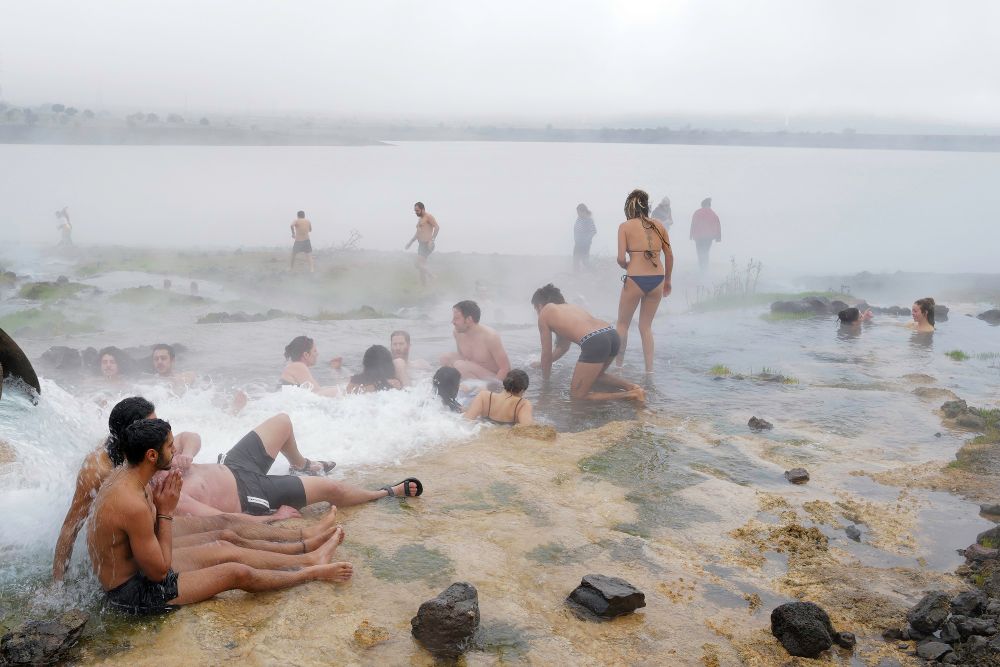 Israelis enjoy a very cold and rainy winter day in the hot springs at Bental water reservoir near Kibbutz Merom Golan, Golan Heights, December 23, 2021.