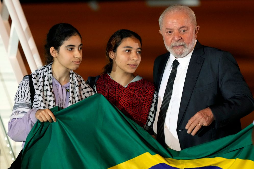 AP Photo/Eraldo Peres Brazil's President Luiz Inacio Lula da Silva talks to two young Brazilian women who were in the Gaza Strip, during their arrival at the Air Base, in Brasilia, Brazil.