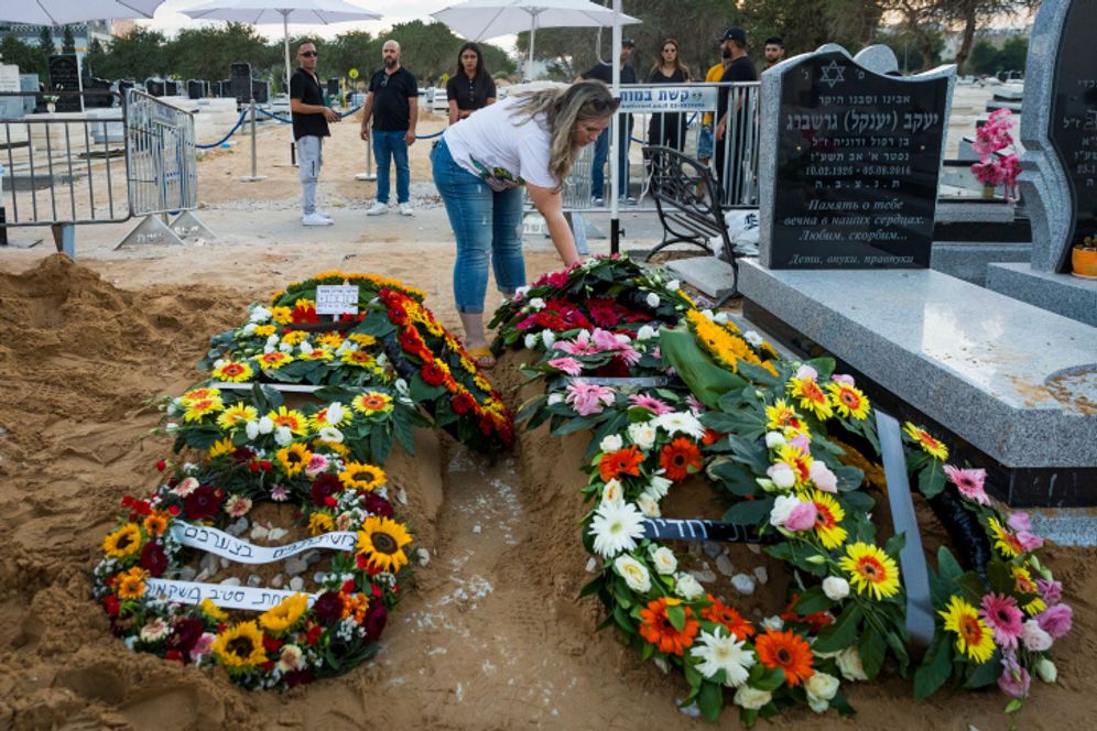 The fresh grave of Shai Nigreker and his son Aviad Nir, who were murdered in the deadly shooting attack in Huwara on Saturday, after their funeral in Ashdod, Israel.