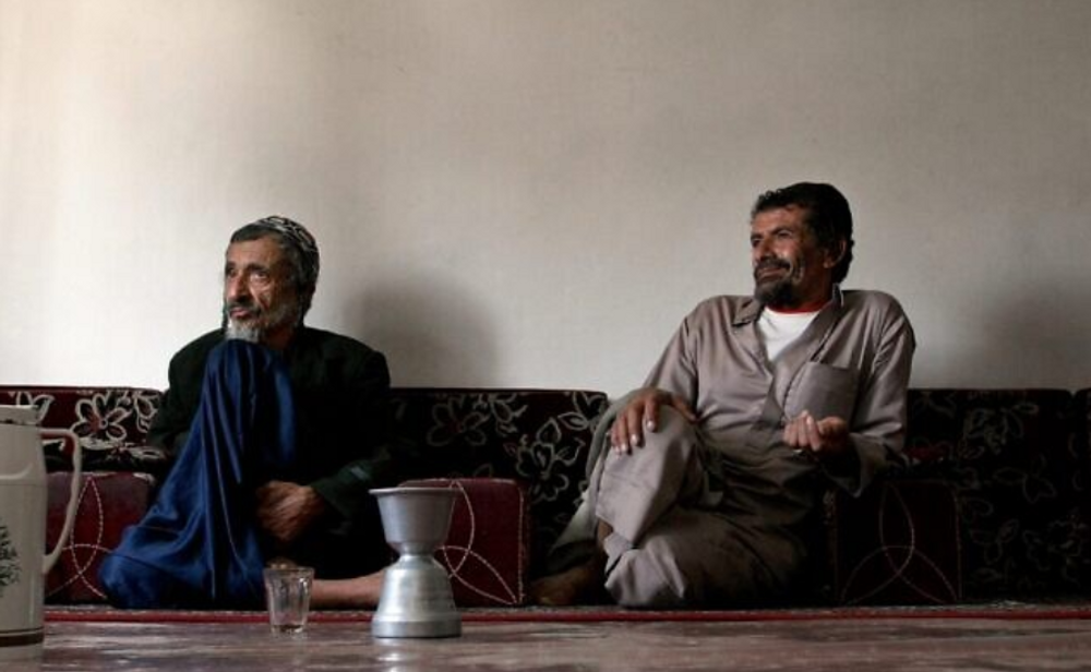 Yemeni Rabbi Youssef Moussa, (L), and his brother Salem sit in an apartment in Sanaa, Yemen, on November 10, 2009, after fleeing the conflict in the north of the country.