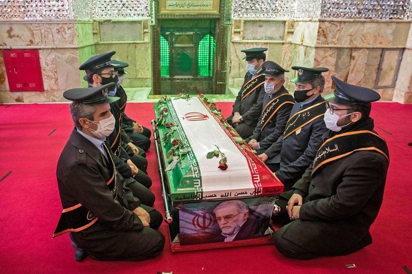 Members of Iranian forces pray around the coffin of slain nuclear scientist Mohsen Fakhrizadeh during the burial ceremony at Imamzadeh Saleh shrine in northern Tehran, on November 30, 2020.