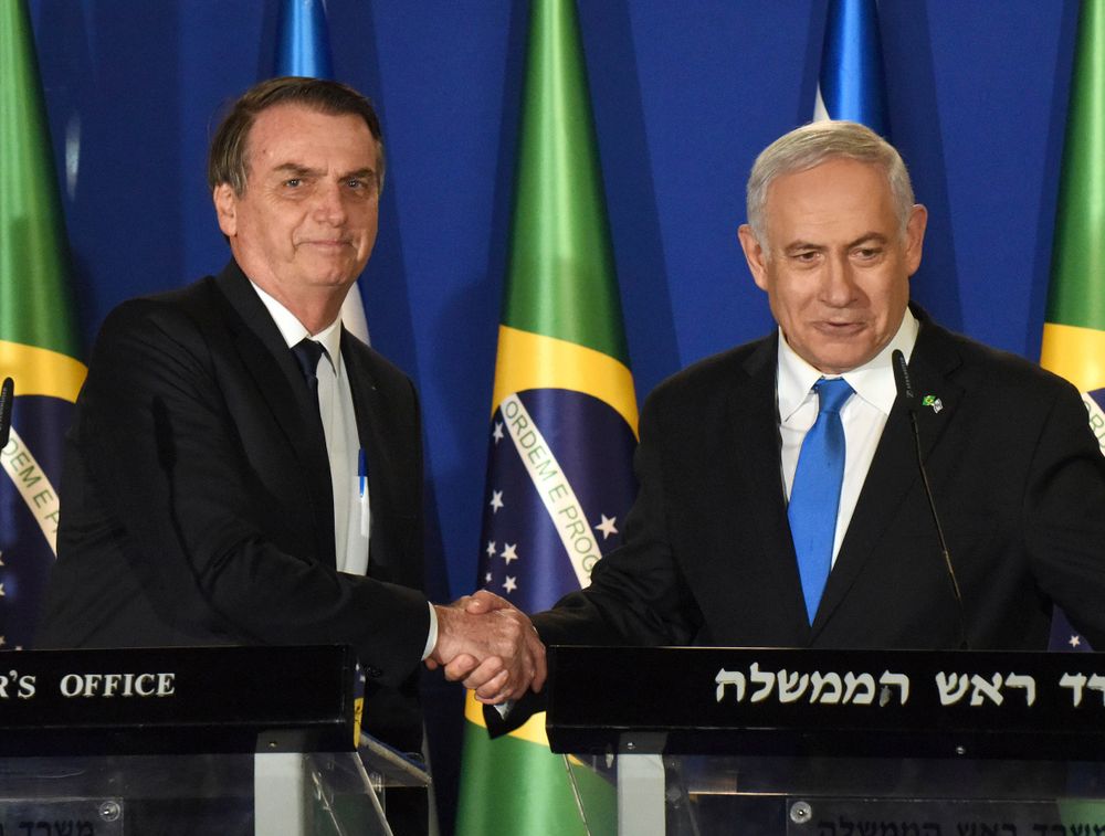 Brazilian President Jair Bolsonaro and Israel Prime Minister Benjamin Netanyahu, right, shake hands during a joint media conference at the prime minister's residence in Jerusalem, Sunday March 31, 2019.