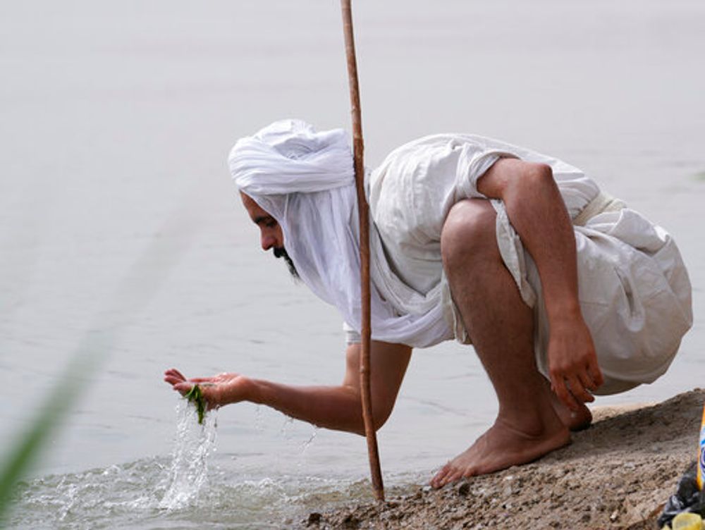 A man performs a ritual in the Tigris River in Baghdad, Iraq, on March 15, 2022.