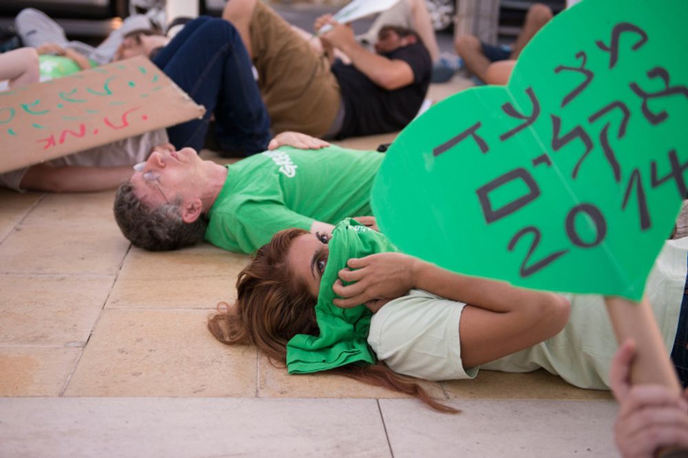 Israelis take part in a protest to demand immediate action on climate change in Tel Aviv, Israel, on September 21, 2014.