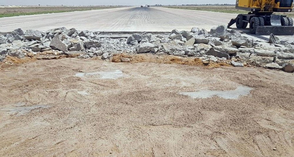 A handout picture released by the official Syrian Arab News Agency (SANA) on June 12, 2022 shows a runway damaged by an Israeli strike that caused the Damascus International Airport to shut down in the Syrian capital.