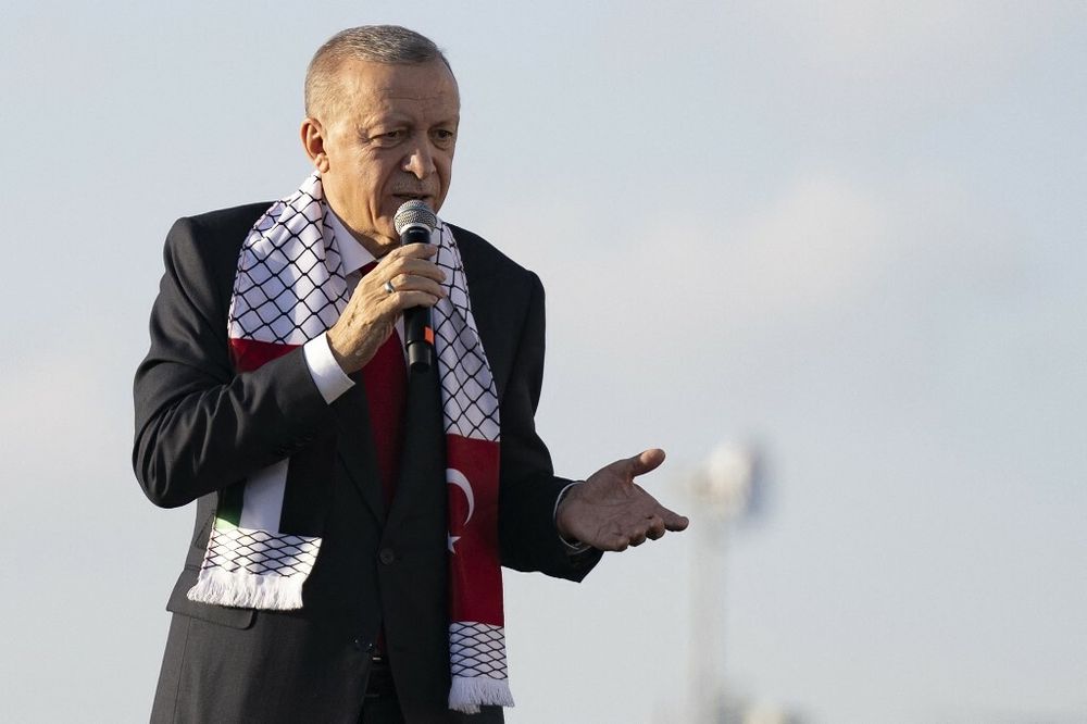 Turkish leader Recep Tayyip Erdogan draped in the Palestinian flag on October 28, 2023. 
