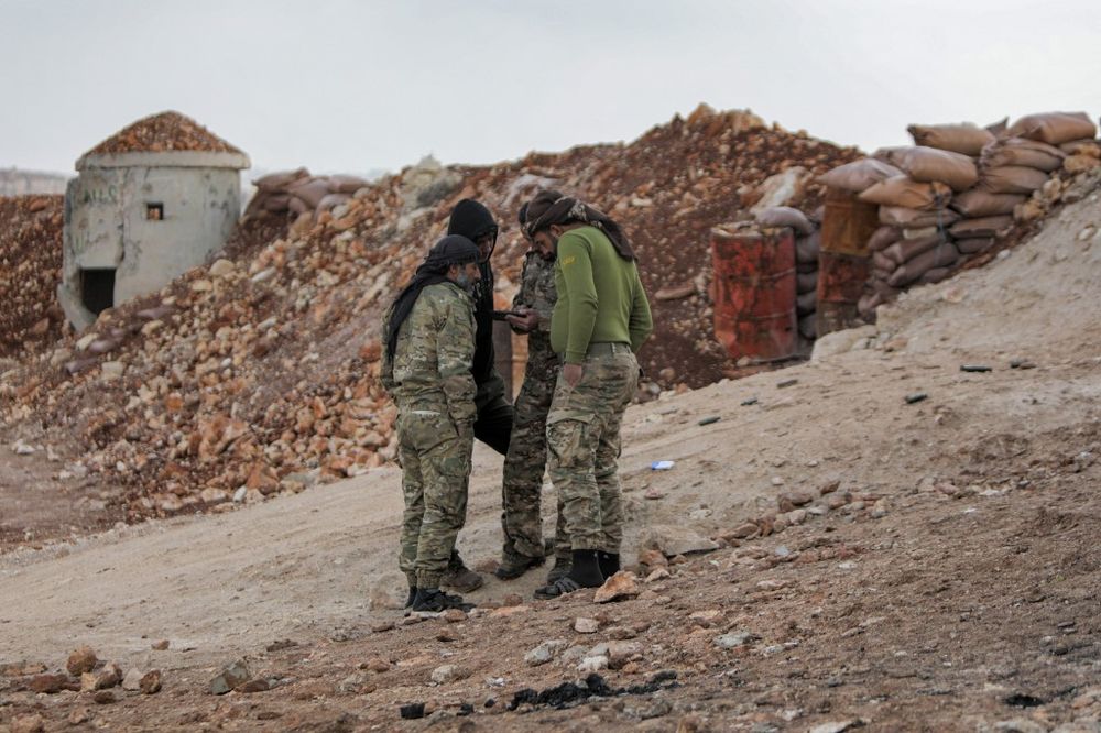 Syrian fighters, affiliated with the Turkish-backed Ahrar al-Sham Islamist group, take position near the village of Tal Jijan, north of the opposition-held city of al-Bab, on the border with Turkey, in Syria's northern Aleppo province.