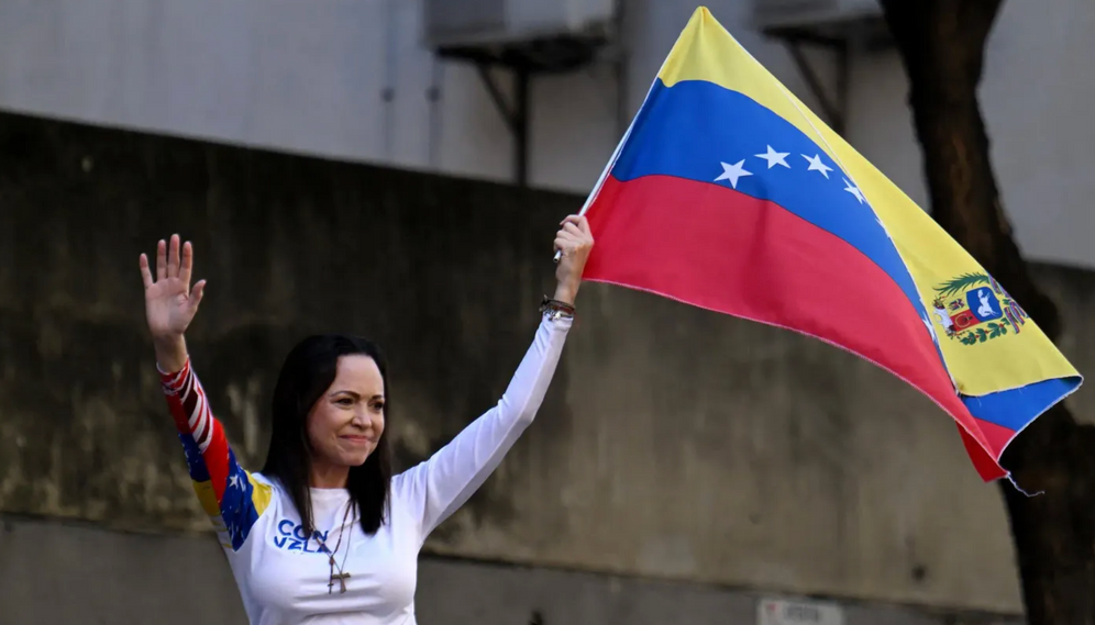 Maria Corina Machado, leader of the Venezuelan opposition, waves a national flag during a demonstration called by the opposition on the eve of the presidential inauguration, in Caracas, on January 9, 2025.