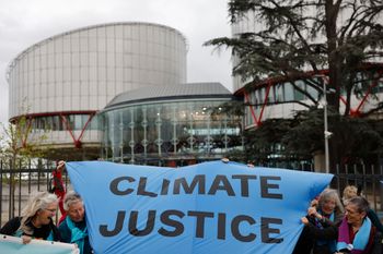 People demonstrate outside the European Court of Human Rights Tuesday, April 9, 2024 in Strasbourg, eastern France.