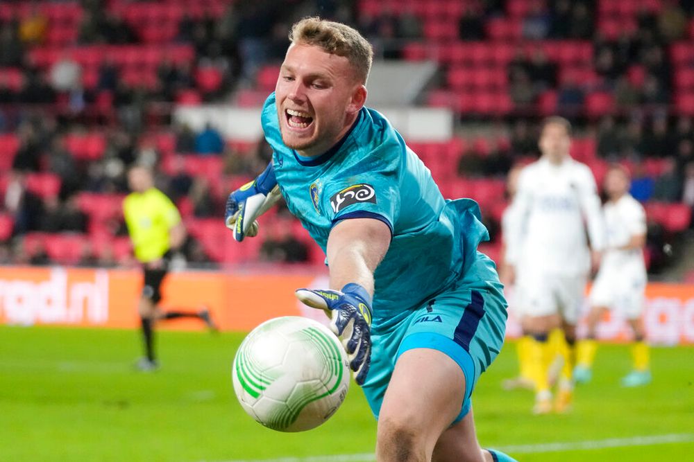 Maccabi's goalkeeper Daniel Peretz tries to keep the ball inside during the first leg play-off Conference League soccer match between PSV and Maccabi Tel Aviv at the Philips stadium in Eindhoven, Netherlands.