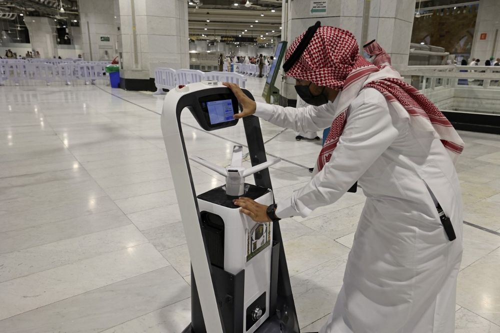 A staff member works on a smart sterilizing robot at the Grand Mosque in Mecca, Saudi Arabia, during the yearly hajj pilgrimage amid the Covid 19 pandemic on July 20, 2021.
