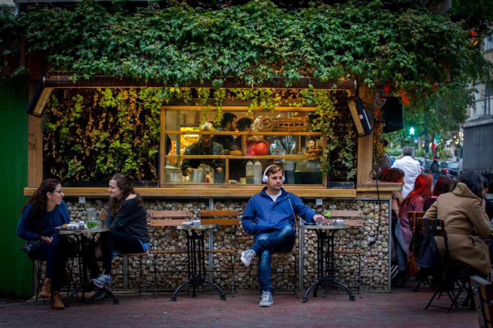 Israelis drinking coffee at a cafe in Tel Aviv, Israel.