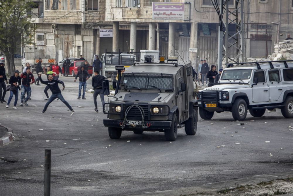 Palestinians clash with Israeli security forces near Joseph's Tomb, in the West Bank city of Nablus, April 13, 2022.