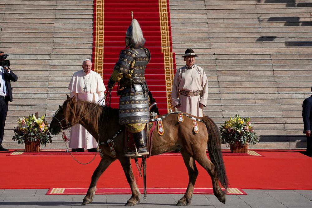 Mongolian President Ukhnaagin Khurelsukh, right, and Pope Francis meet in front of the Saaral Ordon Government Building in Sukhbaatar Square in Ulaanbaatar.