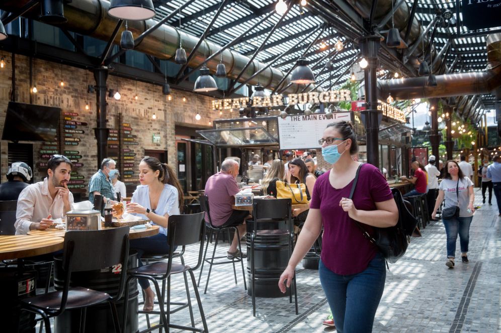 Customers enjoy dining at restaurants at the Sarona Market in Tel Aviv on April 21, 2021.