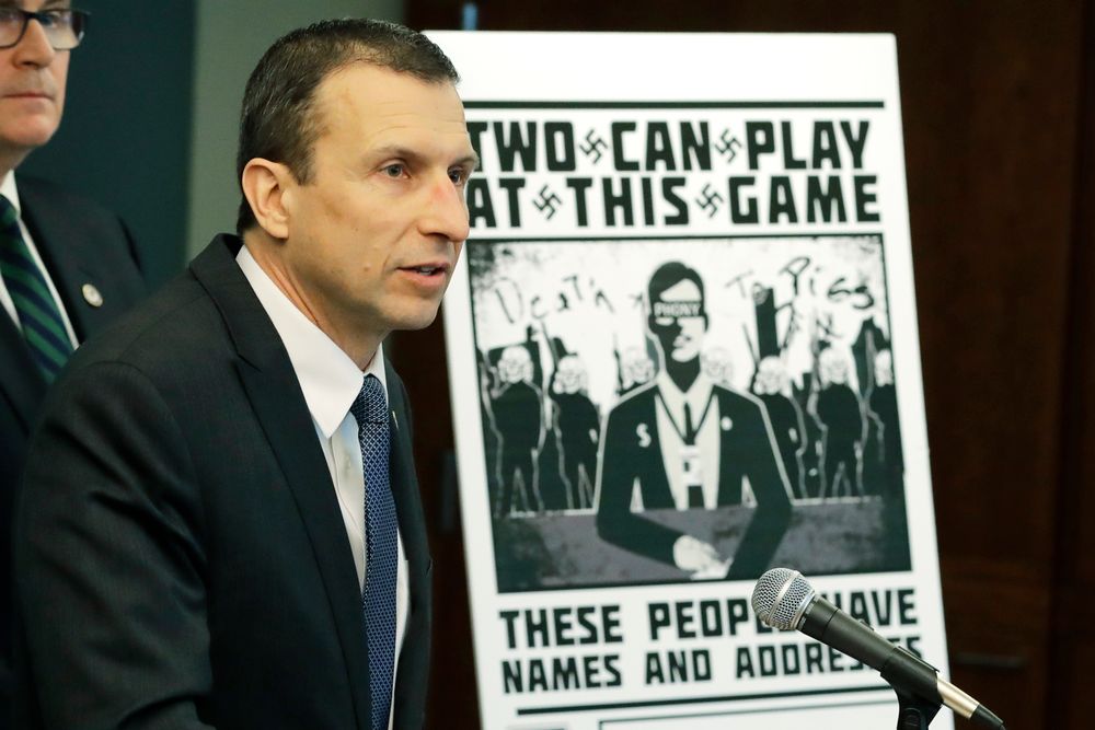 Raymond Duda, FBI Special Agent in Charge in Seattle, speaks as he stands next to a poster that was mailed earlier in the year to the home of Chris Ingalls, an investigative reporter with KING-TV in Seattle, February 26, 2020.