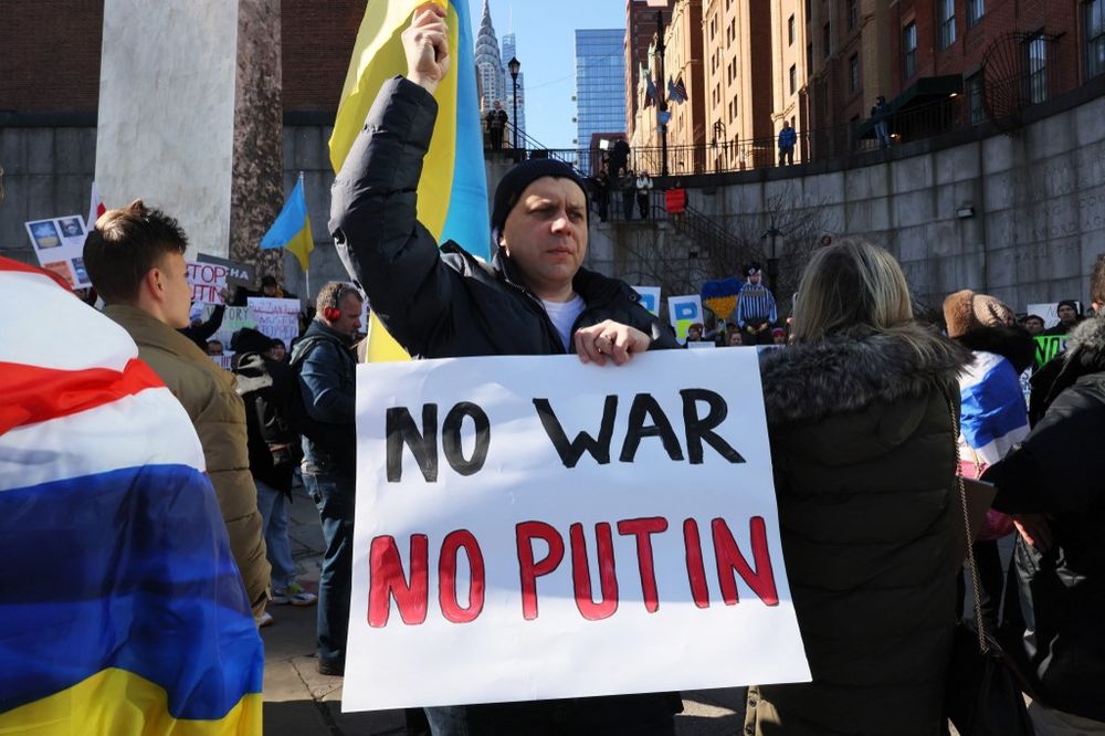 People gather to protest the war in Ukraine on its one-year anniversary at Ralphe Bunche Park in New York, New York.