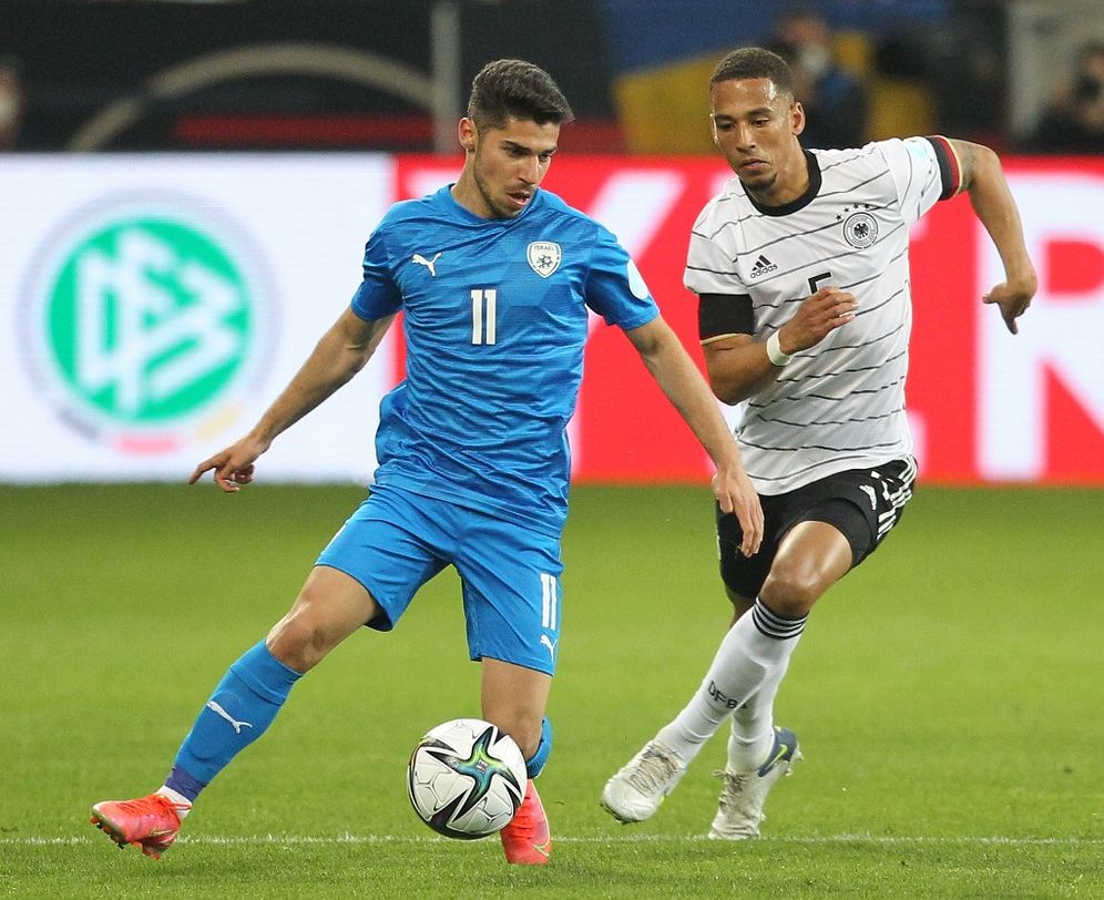 Israeli soccer player Manor Solomon (L) during a friendly football match between Germany and Israel in Sinsheim, Germany, on March 26, 2022.