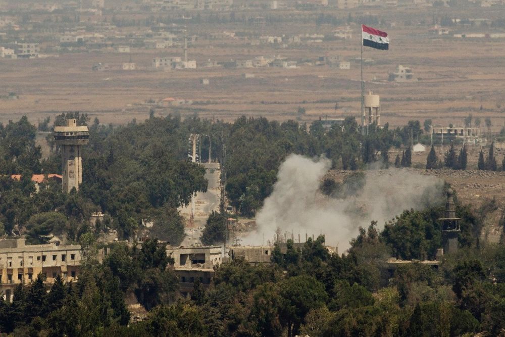 Smoke rises following a Syrian strike in Syria's old city of Quneitra near the border crossing between Syria and the Israeli-controlled Golan Heights, Friday, August 29, 2014.