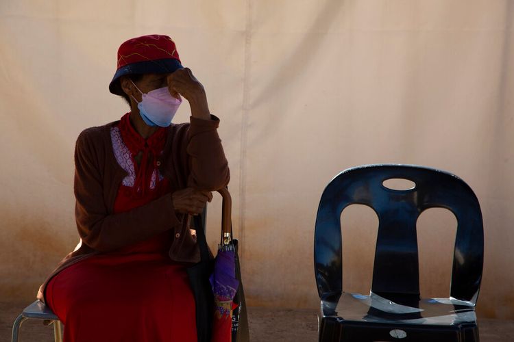 A woman waits in a queue to be screened for Covid at a testing center in Soweto, South Africa, on May 11, 2022.