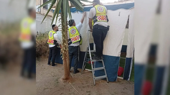 An MDA team finishes building a sukkah for a woman after treating her injuries.
