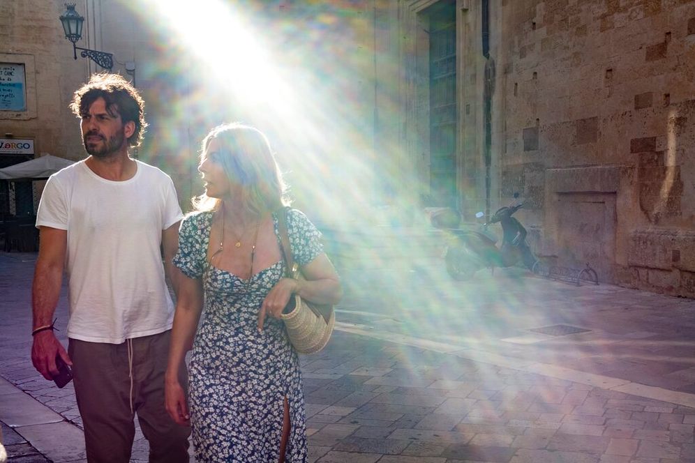 AP Photo/Alexander Zemlianichenko A couple walks down a street during sunset in the old part of Lecce, southern Italy.