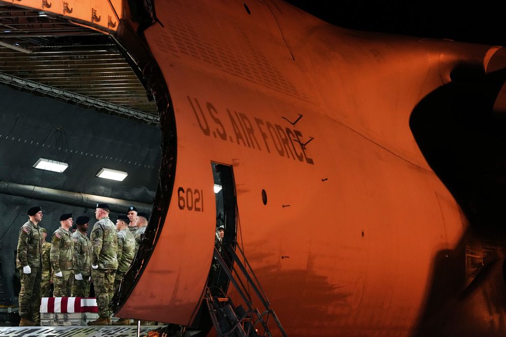 An Army carry team stands before moving the flag-draped transfer case containing the remains of U.S. Army soldier Maj. Sorffly Davius, of Cambria Heights, N.Y., who died in Kuwait, during a casualty return, Monday, March 9, 2026,