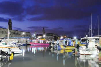 Backdropped by the Old City, fishing boats in the port in the northern Israeli city of Acre, July 9, 2013.