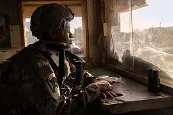 A U.S. Army soldier looks onto Baghdad from a guardhouse on the perimeter of the International Zone in Baghdad, Iraq, a file photo.