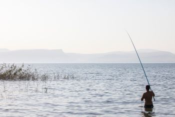 A person fishing in the Sea of Galilee next to the city of Tiberias in northern Israel, on June 23, 2015.