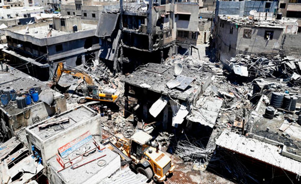 Palestinian rescuers and security personnel work at the scene of an explosion in the Al-Zawiya market area of Gaza City, Gaza, on July 22, 2021.
