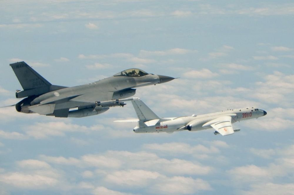 Taiwan's Air Force F-16 fighter aircraft (L) flying alongside a Chinese People's Liberation Army Air Force H-6K, on May 11, 2018.