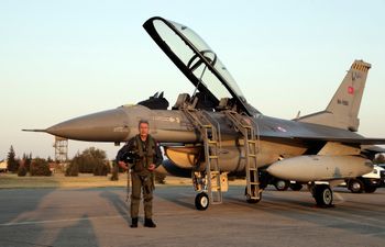 Turkey's Defense Minister Hulusi Akar poses for photos in front of an F-16 jet fighter at a military air base in western city of Eskisehir, Turkey, September 2, 2020.