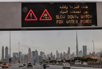 An electronic sign warns motorists of slippery roads as heavy rains hit the Gulf emirate of Dubai, on January 1, 2022.
