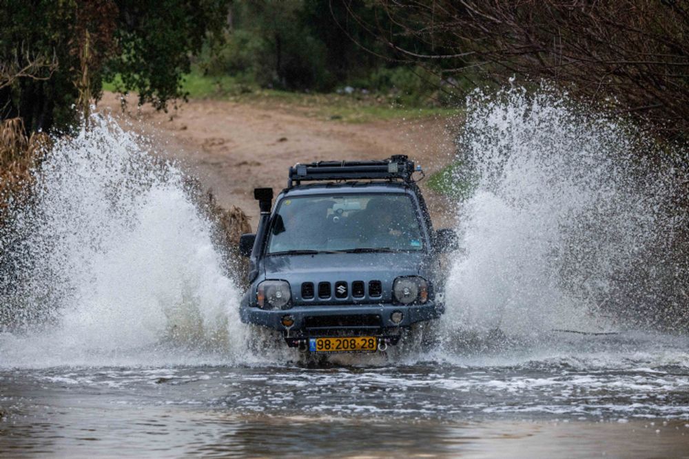 A man drives his car at the Refaim Stream in the Jerusalem Mountains, on February 26, 2022.