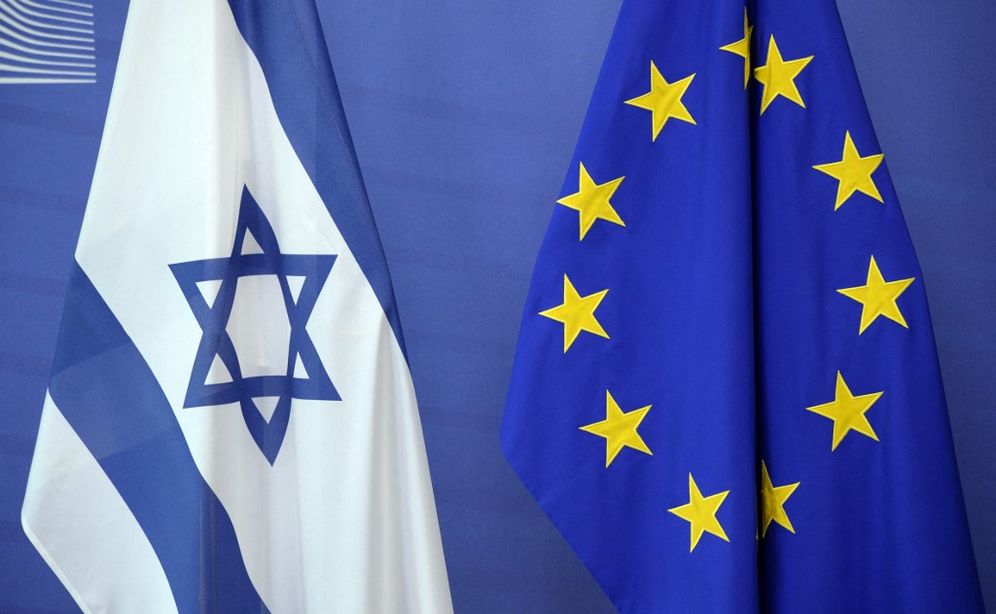 An Israeli flag (L) is set next to a European Union flag in Brussels, Belgium.