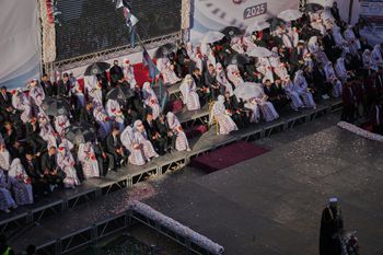 Palestinian couples participate in a mass wedding ceremony in Hamad City in Khan Younis, Gaza Strip, Tuesday, Dec. 2, 2025