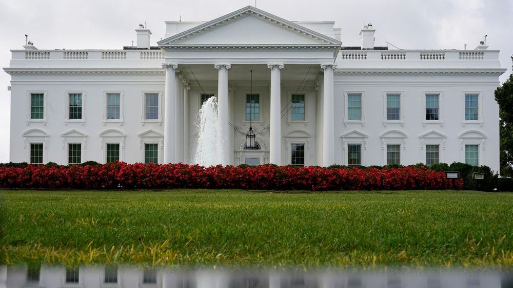 FILE - The White House is seen reflected in a puddle, Saturday, September 3, 2022, in Washington.