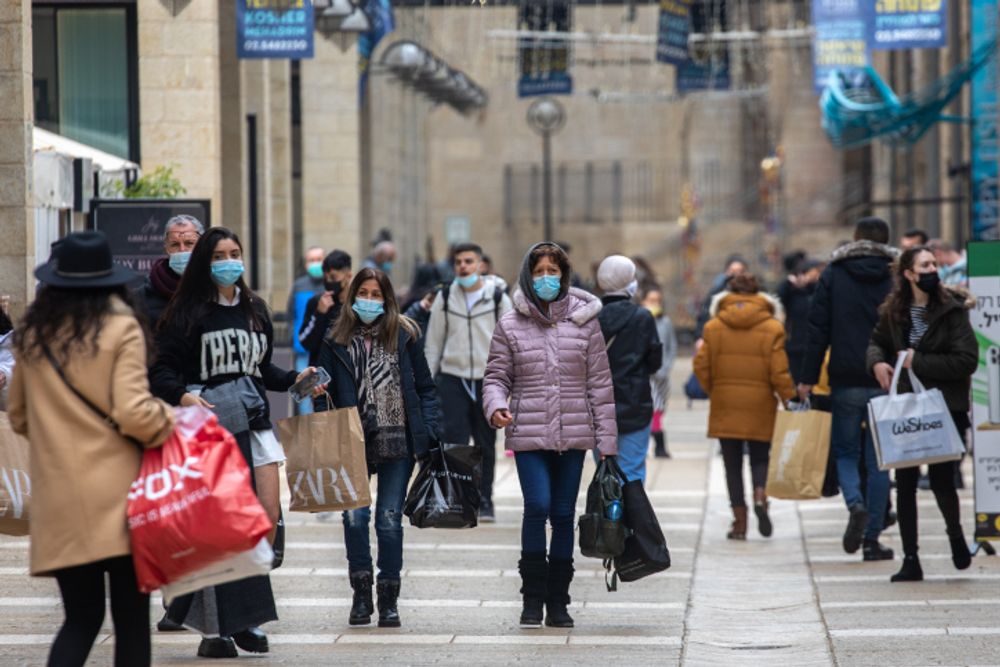 Jerusalemites wearing a face mask shop at the Mamilla mall in Jerusalem on March 01, 2021 as Israel exits a 3rd lockdown due to the COVID-19 coronavirus pandemic.