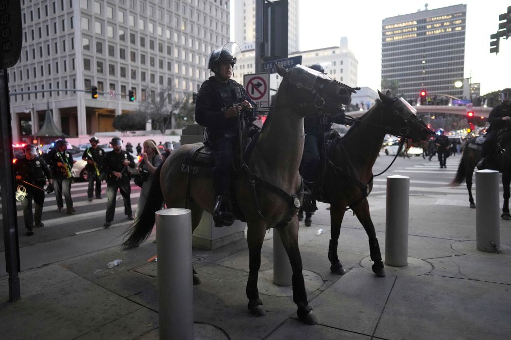 Los Angeles Police Department officers on horseback move through a street during a protest on Tuesday, June 10, 2025, in Los Angeles. ()


