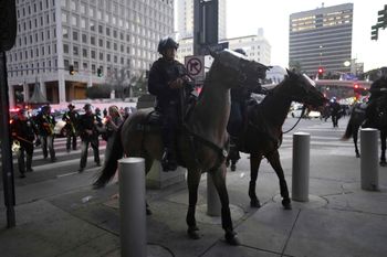 Los Angeles Police Department officers on horseback move through a street during a protest on Tuesday, June 10, 2025, in Los Angeles. ()


