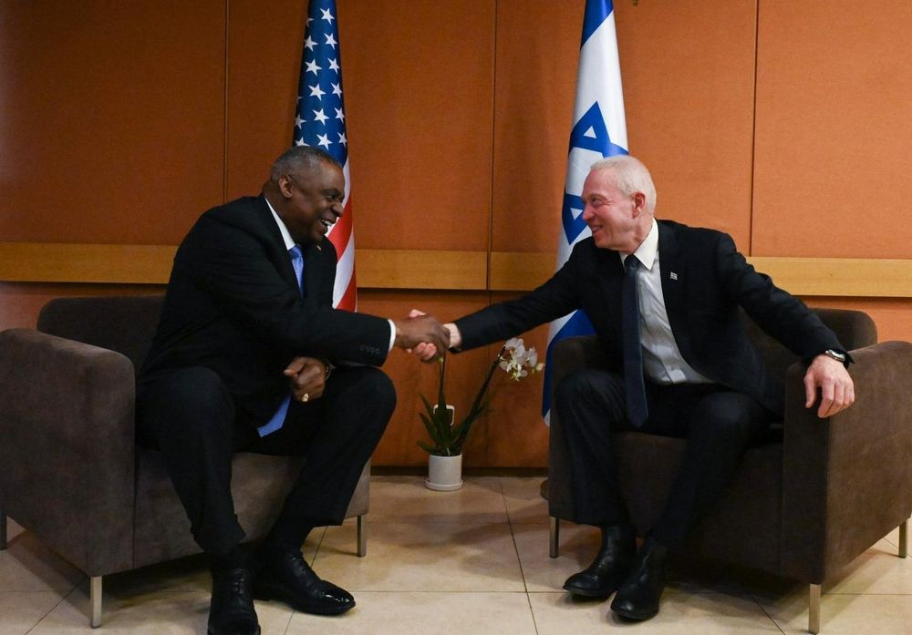 Israel's Defense Minister Yoav Gallant (R) greets Pentagon chief Lloyd Austin.