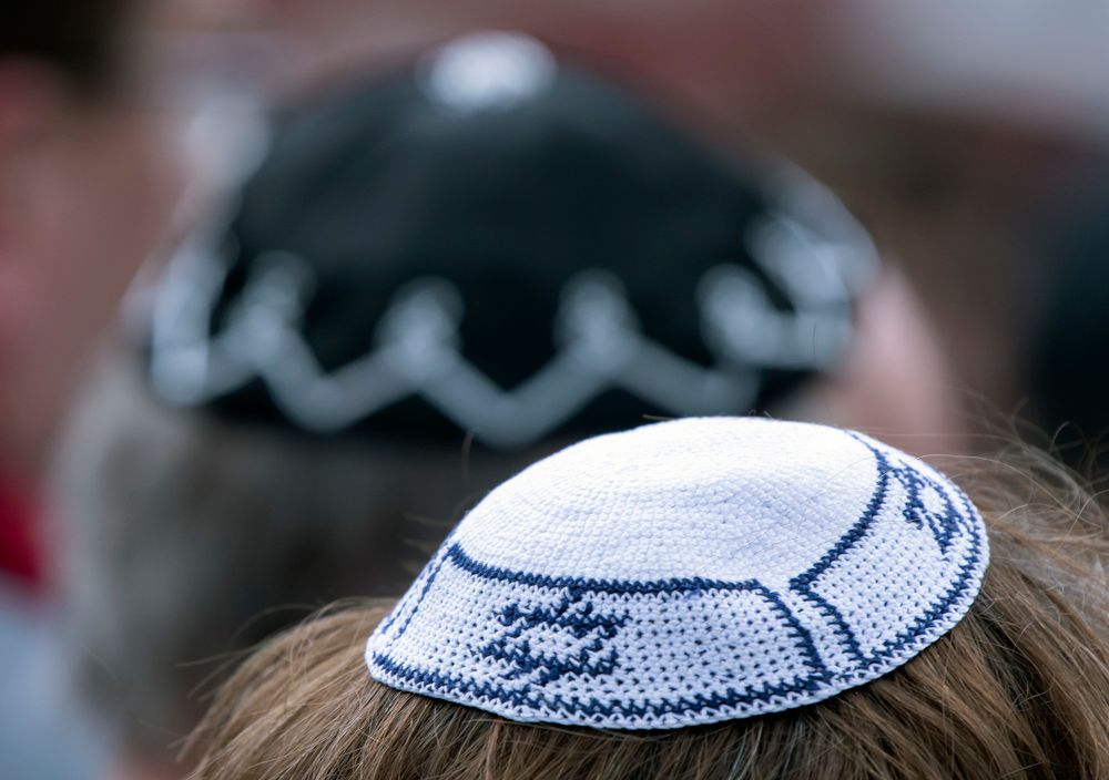 People of different faiths wear yarmulkes during a protest against antisemitism in Germany in Erfurt, April 25, 2018.