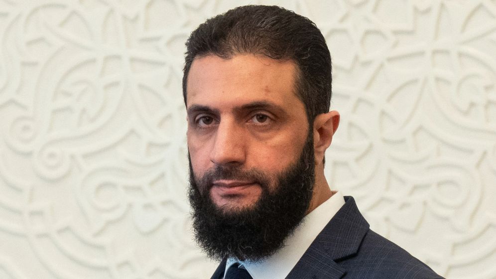 Syria's de facto leader Ahmad al-Sharaa, formerly known as Abu Mohammed al-Golani, walks in the presidential palace ahead of his meeting with Walid Ellafi, Libyan minister of state for communication and political affairs, in Damascus, Saturday, Dec. 28, 2024.