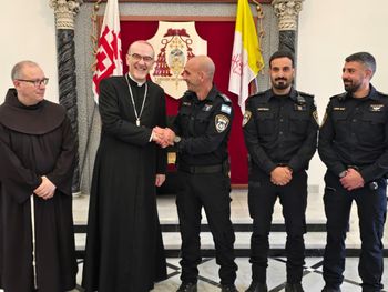 Israeli policemen pose with Cardinal Pierbattista Pizzaballa for a photo