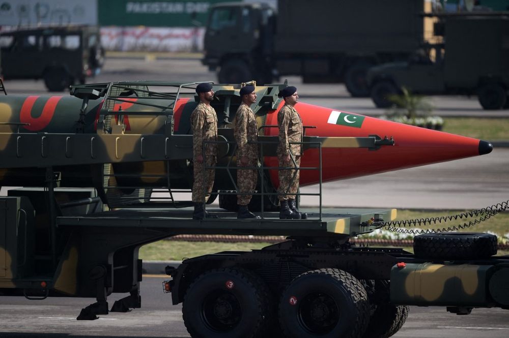 Pakistani military personnel stand beside a Ghauri nuclear-capable missile during a Pakistan Day military parade in Islamabad on March 23, 2017.